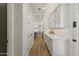 Bright hallway featuring sleek cabinets and hardwood floors, leading to the rest of the home at 12956 N 152Nd Ave, Surprise, AZ 85379