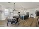 Open-concept kitchen with a dining area, stainless steel appliances, a large island, and modern lighting at 12956 N 152Nd Ave, Surprise, AZ 85379