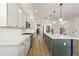 A modern kitchen features an island, stainless steel appliances, light-colored cabinets, and sleek countertops at 12956 N 152Nd Ave, Surprise, AZ 85379