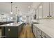 Open-concept kitchen boasts a large island with a breakfast bar, stainless steel appliances, and sleek countertops at 12956 N 152Nd Ave, Surprise, AZ 85379