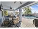 Inviting covered patio with outdoor kitchen and dining area overlooking the sparkling pool at 12956 N 152Nd Ave, Surprise, AZ 85379