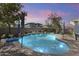 Stunning pool with rock waterfall feature and lush landscaping, perfect for relaxation at 12956 N 152Nd Ave, Surprise, AZ 85379