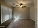Sunlit bedroom with tile flooring, ceiling fan, and a large window with blinds at 1304 S Owl Dr, Gilbert, AZ 85296