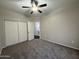 Bedroom with carpet, neutral walls, ceiling fan, closet, and en suite bathroom at 1304 S Owl Dr, Gilbert, AZ 85296