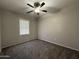 Bedroom featuring neutral walls and plush carpeting, ceiling fan, and a window with blinds for ample natural light at 1304 S Owl Dr, Gilbert, AZ 85296