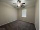 Bedroom featuring neutral walls and plush carpeting, ceiling fan, and a window with blinds for ample natural light at 1304 S Owl Dr, Gilbert, AZ 85296