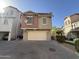 Two-story home with an attached garage, a well-kept lawn, and a cozy residential appeal at 1304 S Owl Dr, Gilbert, AZ 85296