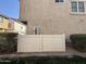 Exterior view of the home's side featuring a fenced area and access doors, providing privacy at 1304 S Owl Dr, Gilbert, AZ 85296