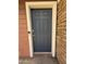 Stylish gray front door with a smart lock system and a charming stone and wood exterior at 1304 S Owl Dr, Gilbert, AZ 85296