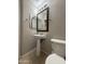 This half bath includes a pedestal sink with a modern faucet, a framed mirror, and neutral wall color at 1304 S Owl Dr, Gilbert, AZ 85296