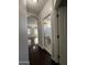 Hallway with wood floors, leading to the bathroom and living room, enhanced by ample natural light at 1304 S Owl Dr, Gilbert, AZ 85296