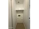 A compact laundry closet with white walls, one shelf, and hookups ready for a washer and dryer at 1304 S Owl Dr, Gilbert, AZ 85296