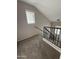This carpeted staircase is accented by modern black metal and light wood banisters at 1304 S Owl Dr, Gilbert, AZ 85296