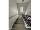 Well-lit staircase with carpeted steps and a contemporary black and wood railing at 1304 S Owl Dr, Gilbert, AZ 85296