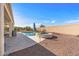 The backyard features a pool, spa, patio, desert landscaping, and a block fence at 13616 W Junipero Dr, Sun City West, AZ 85375