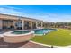 Wonderful backyard featuring a pool, spa, covered patio with seating, and desert landscaping at 13616 W Junipero Dr, Sun City West, AZ 85375