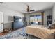 Bedroom features a ceiling fan, a TV on a dresser, and access to the outdoor area with a pool at 13616 W Junipero Dr, Sun City West, AZ 85375