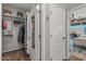 A walk-in closet provides ample storage, with the bedroom and outdoor space visible beyond at 13616 W Junipero Dr, Sun City West, AZ 85375
