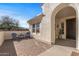 Cozy courtyard with seating area, brick paving, and access to the home's entrance and adjacent window at 13616 W Junipero Dr, Sun City West, AZ 85375