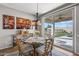 Bright dining area with a stylish table and chairs offers views of the backyard pool at 13616 W Junipero Dr, Sun City West, AZ 85375