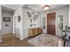 Spacious entryway with decorative rug, light-colored walls, and stylish wooden console table at 13616 W Junipero Dr, Sun City West, AZ 85375