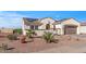 Attractive home featuring desert landscaping, tile roof, an arched entryway, and a two-car garage, plus solar panels at 13616 W Junipero Dr, Sun City West, AZ 85375