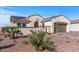 Inviting single-story home with desert landscaping, private courtyard entrance, two-car garage, and solar panels on the roof at 13616 W Junipero Dr, Sun City West, AZ 85375