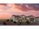 Charming single-story home with desert landscaping, private courtyard, and solar panels at dusk at 13616 W Junipero Dr, Sun City West, AZ 85375