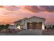 Inviting single-story home with a private courtyard, two-car garage and desert landscaping under a beautiful sunset sky at 13616 W Junipero Dr, Sun City West, AZ 85375