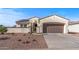 Charming home with desert landscaping, arched entry, a two-car garage, and solar panels on the roof, plus paved driveway at 13616 W Junipero Dr, Sun City West, AZ 85375