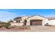 Lovely home with desert landscaping, arched entry, a two-car garage, and solar panels on the roof, plus paved driveway at 13616 W Junipero Dr, Sun City West, AZ 85375