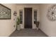 Inviting front entrance with security door, decorative sidelights, and stylish decor accents at 13616 W Junipero Dr, Sun City West, AZ 85375