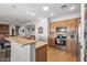 Well-lit kitchen with stainless steel appliances and an eat-in bar, offering a seamless cooking experience at 13616 W Junipero Dr, Sun City West, AZ 85375