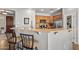 Kitchen featuring wooden cabinets, stainless steel appliances, and an eat-in breakfast bar at 13616 W Junipero Dr, Sun City West, AZ 85375