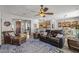 Open-concept living area with views to the kitchen, dining space, and front entryway at 13616 W Junipero Dr, Sun City West, AZ 85375