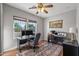 Home office features two desks, ample lighting from two large windows, and an area rug at 13616 W Junipero Dr, Sun City West, AZ 85375