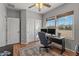 Home office space has two large windows, a desk, and a closet for storage solutions at 13616 W Junipero Dr, Sun City West, AZ 85375