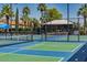 Outdoor pickleball court with black chain link fence in a sunny setting at 13616 W Junipero Dr, Sun City West, AZ 85375