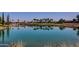 Scenic view of pond reflecting surrounding golf course and desert landscaping at 13616 W Junipero Dr, Sun City West, AZ 85375