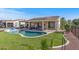 Backyard pool and spa with covered patio, outdoor living space and artificial grass at 13616 W Junipero Dr, Sun City West, AZ 85375
