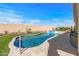 Backyard pool with water feature, covered patio, outdoor living space and artificial grass at 13616 W Junipero Dr, Sun City West, AZ 85375