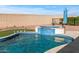 This backyard pool has a spa and desert landscaping at 13616 W Junipero Dr, Sun City West, AZ 85375