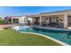 Backyard pool and spa with outdoor living space, covered patio and artificial grass at 13616 W Junipero Dr, Sun City West, AZ 85375