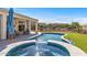 A beautiful pool and spa with a covered patio, and desert landscaping at 13616 W Junipero Dr, Sun City West, AZ 85375