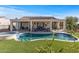 Backyard pool and spa with covered patio, outdoor living space and artificial grass at 13616 W Junipero Dr, Sun City West, AZ 85375
