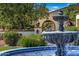 Ornate water feature with lush landscaping at 13616 W Junipero Dr, Sun City West, AZ 85375