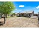 This large backyard features grass, desert landscaping, and a covered patio at 14398 W Marcus Dr, Surprise, AZ 85374