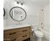 This bathroom features a modern vanity, stylish mirror, and a combined shower and tub at 14398 W Marcus Dr, Surprise, AZ 85374