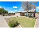 Charming single-story home with a well-maintained lawn, desert landscaping, and a two-car garage at 14398 W Marcus Dr, Surprise, AZ 85374