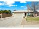 Charming single-story home with a two-car garage, desert landscaping, and a well-maintained lawn at 14398 W Marcus Dr, Surprise, AZ 85374